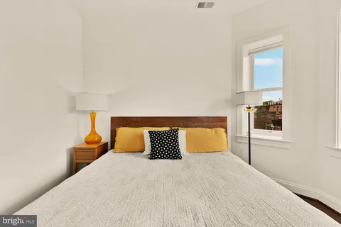 a bedroom with a bed and night stand