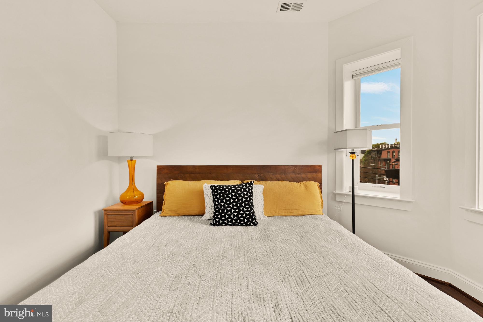 1249 Kenyon Street Northwest, Unit 4 Washington, DC 20010 - Photo 15 of 30 a bedroom with a bed and night stand