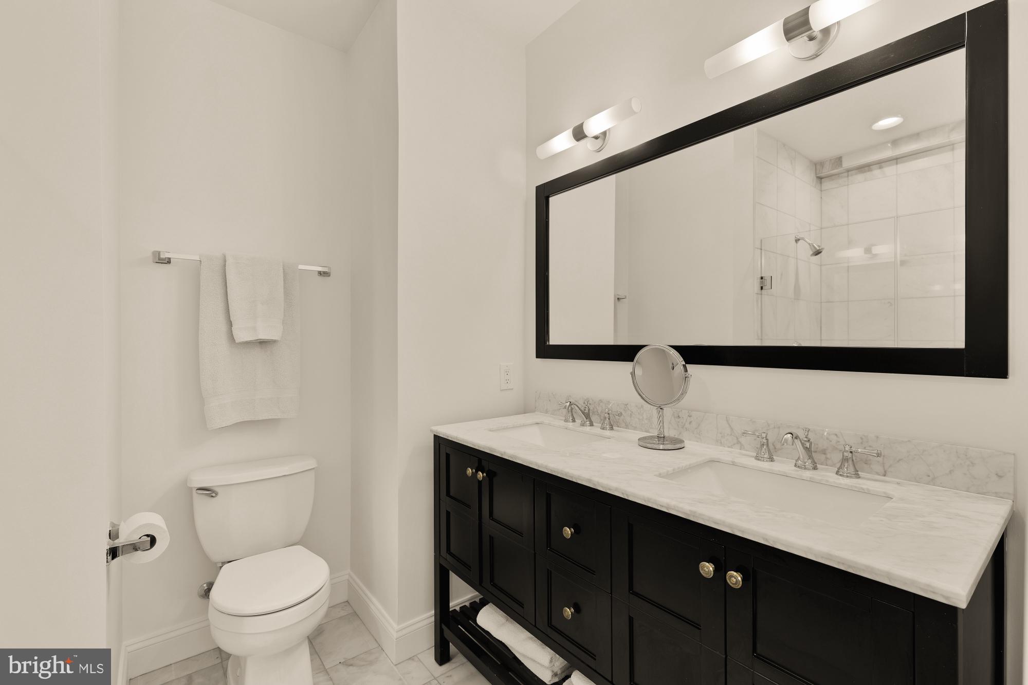 1249 Kenyon Street Northwest, Unit 4 Washington, DC 20010 - Photo 18 of 30 a bathroom with a granite countertop sink toilet and mirror