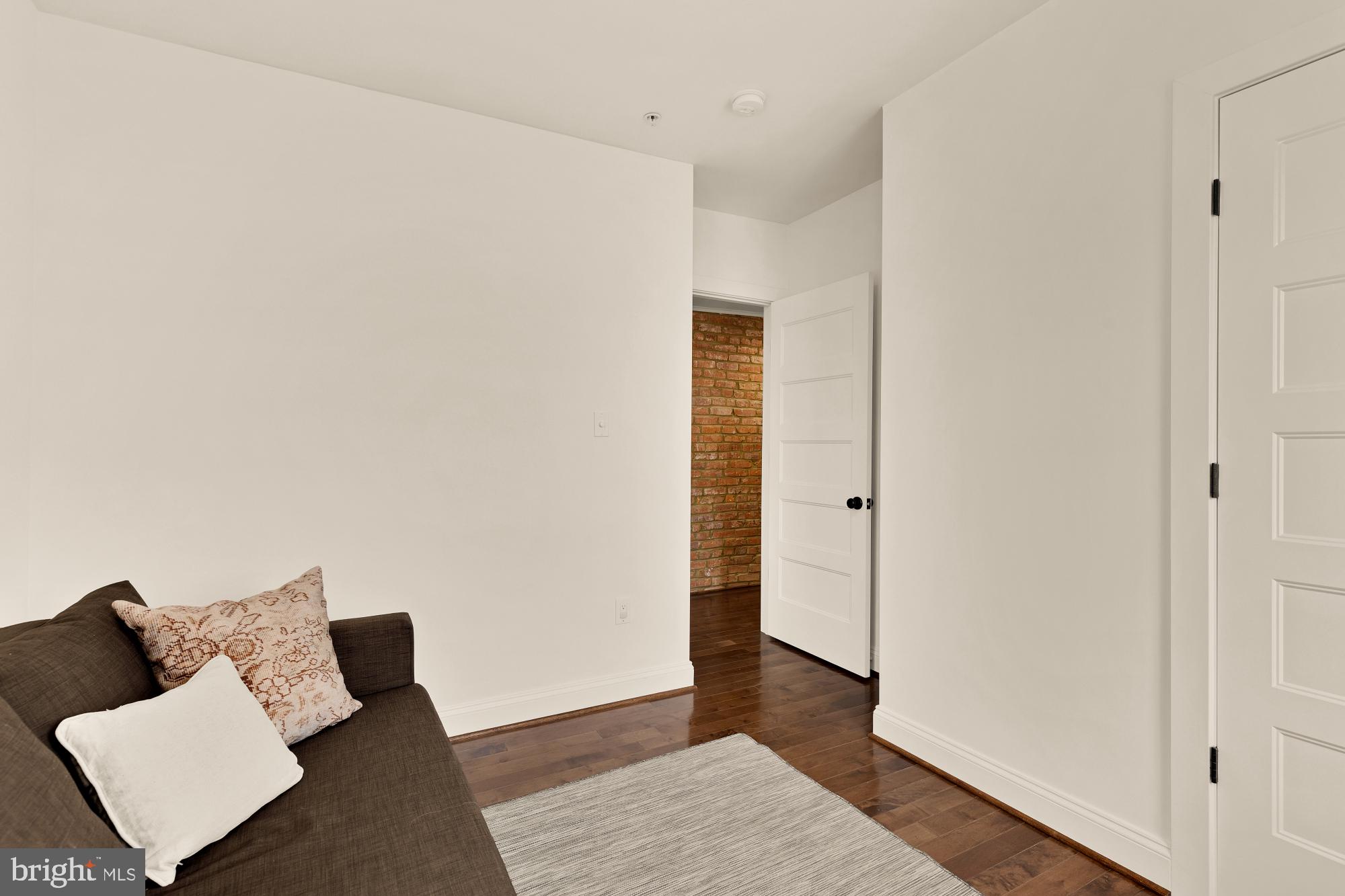 1249 Kenyon Street Northwest, Unit 4 Washington, DC 20010 - Photo 21 of 30 a living room with furniture and wooden floor