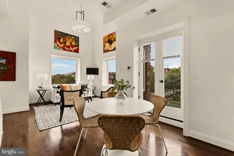 a dining room with furniture and wooden floor