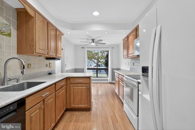 a kitchen with a sink stove and refrigerator