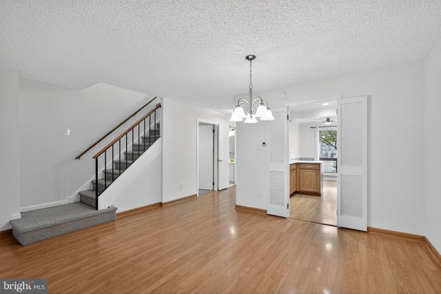 a view of a livingroom with wooden floor and staircase