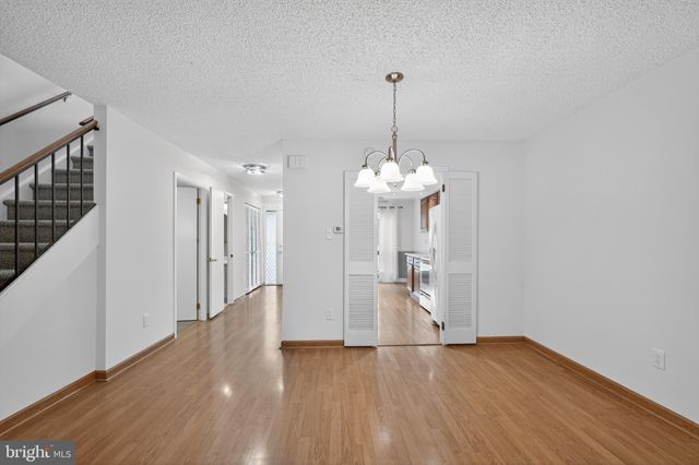 a view of a room with wooden floor and staircase