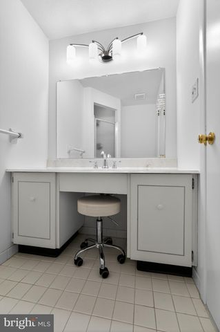 a bathroom with a sink vanity and a mirror