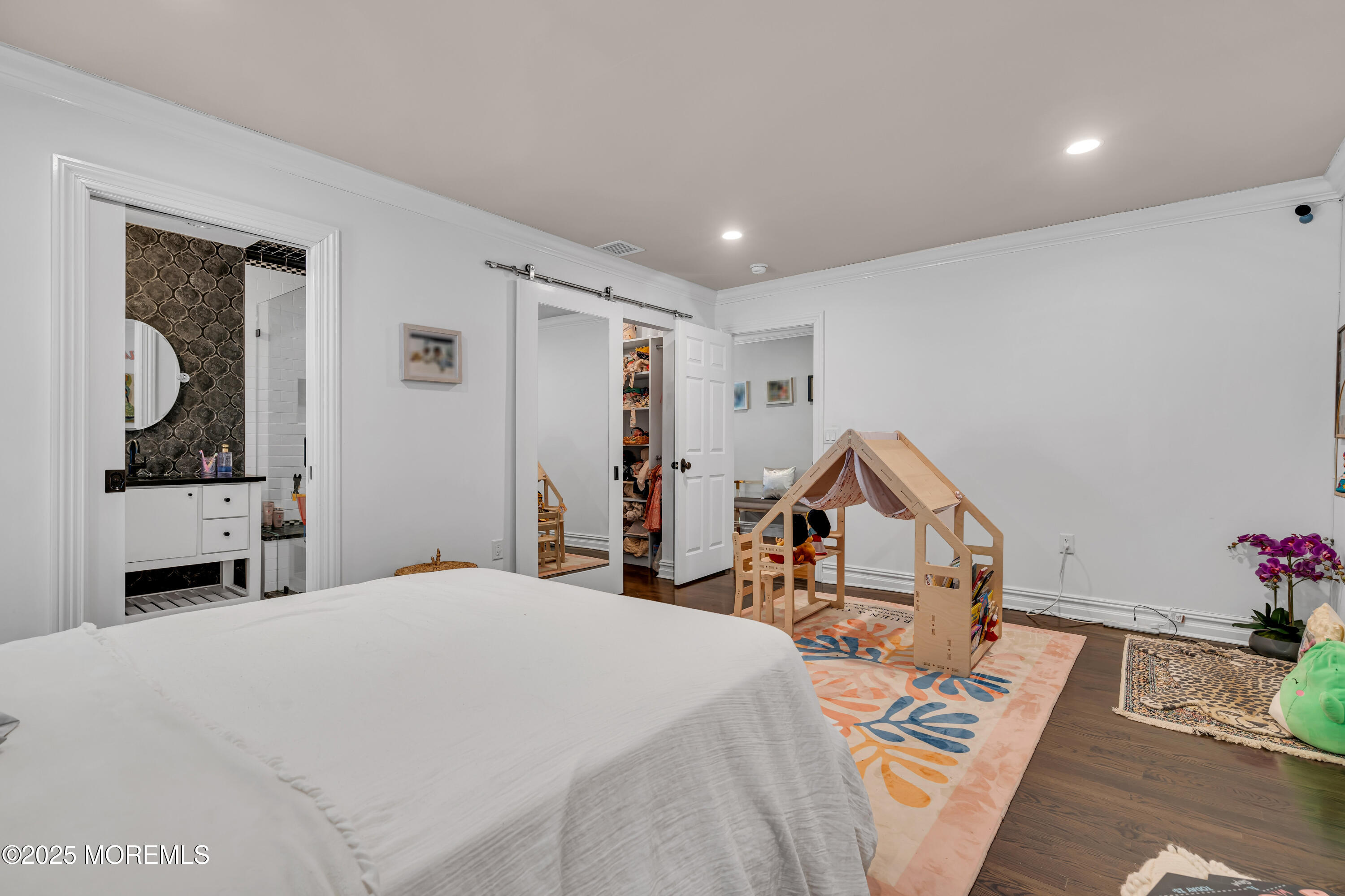 91 Ridge Road Rumson, NJ 07760 - Photo 46 of 80 a bed room with a bed and a chandelier