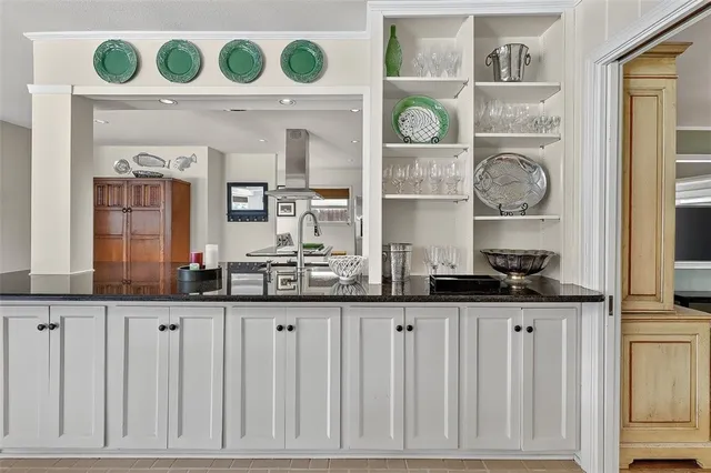 a kitchen with a cabinets and a clock on the wall