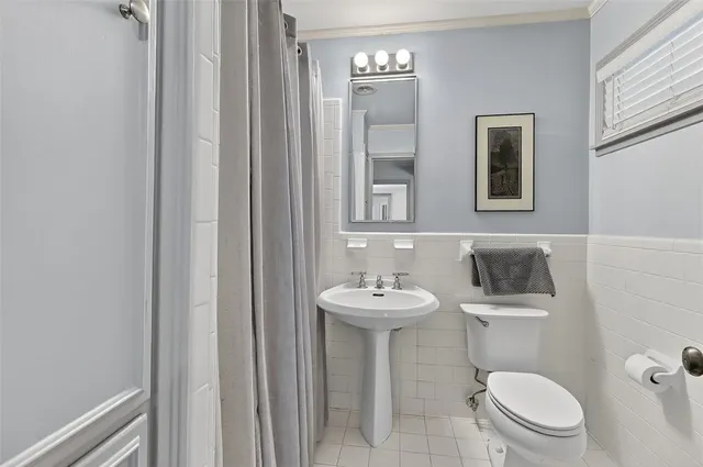 a spacious bedroom with a bed and a window