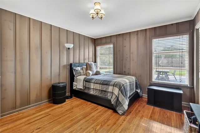 a bedroom with furniture and wooden floor