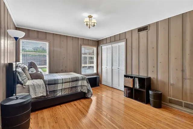 a bedroom with a bed and a chandelier