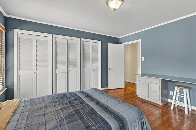 a bedroom with a large bed and a dresser