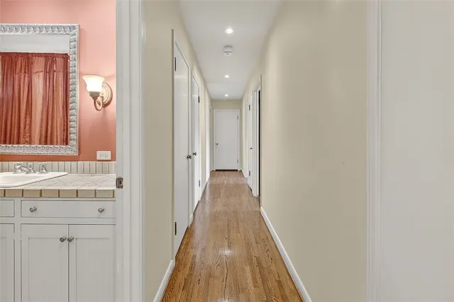 a bathroom with a sink a toilet a mirror and bathtub