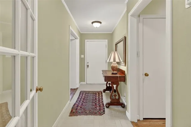 a view of an entryway with a table and chairs