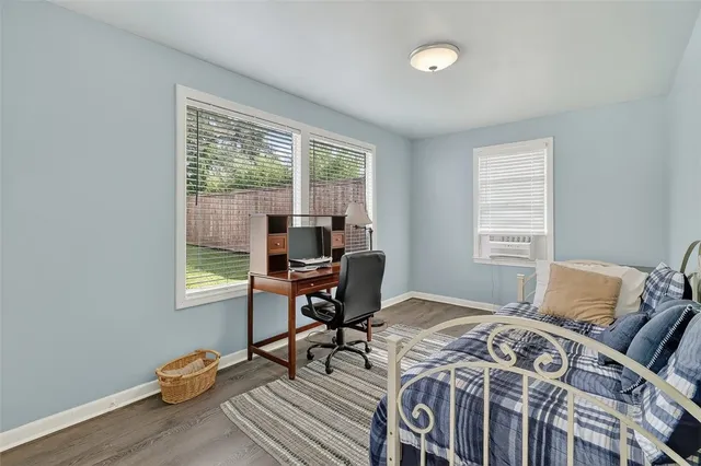 a bed room with a bed and a chair