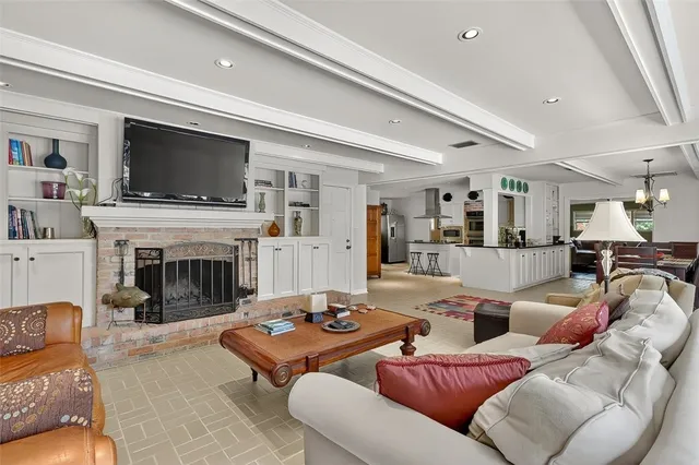 a living room with furniture fireplace and flat screen tv