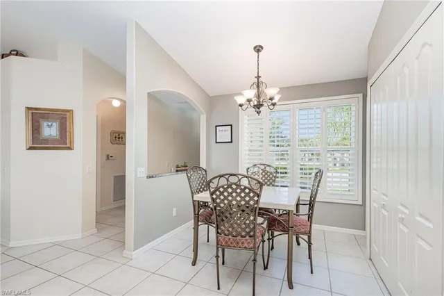 a view of a dining room with furniture and chandelier