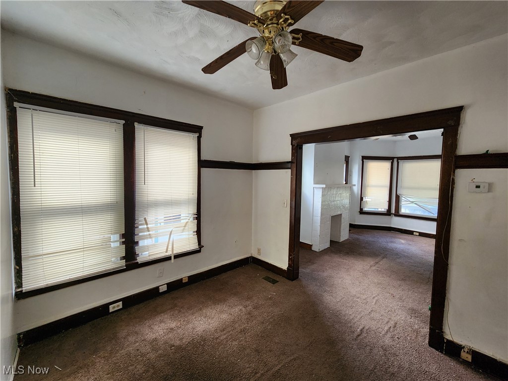 1614 Holyrood Road Cleveland, OH 44106 - Photo 9 of 21 Spare room featuring ceiling fan and dark carpet