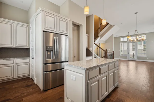 a kitchen with a refrigerator a sink and cabinets