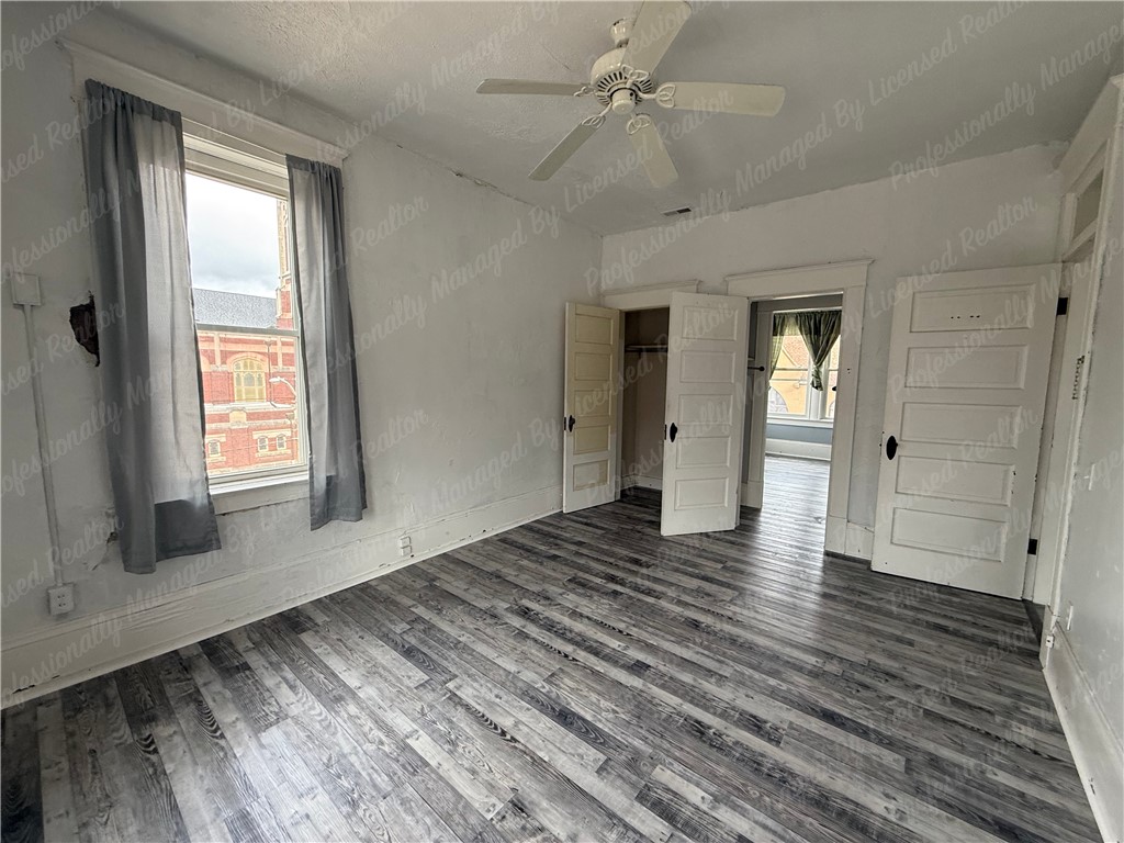 44 West High Street, Unit D Springfield, OH 45502 - Photo 10 of 25 This airy bedroom features durable flooring and abundant natural light, creating a comfortable living space.