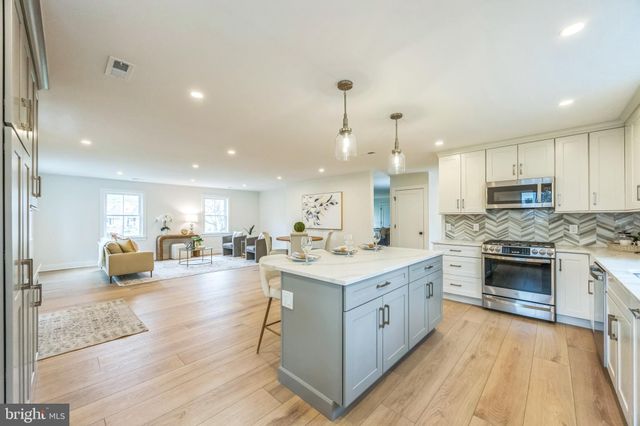 a large kitchen with stainless steel appliances lots of counter space