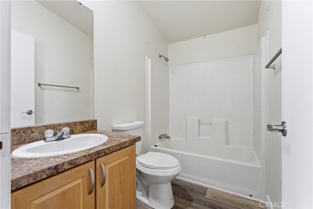 20843 Waalew Road, Unit C125 Apple Valley, CA 92307 - Photo 12 of 38 a bathroom with a granite countertop sink toilet and shower