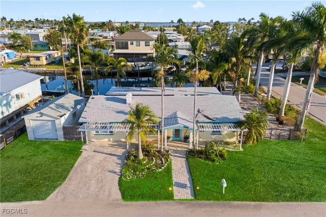 a front view of a house with a garden and yard