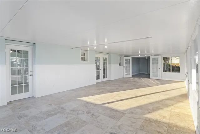 an empty room with windows and entrance