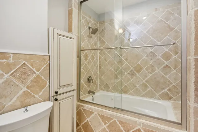 a bathroom with a bathtub and shower