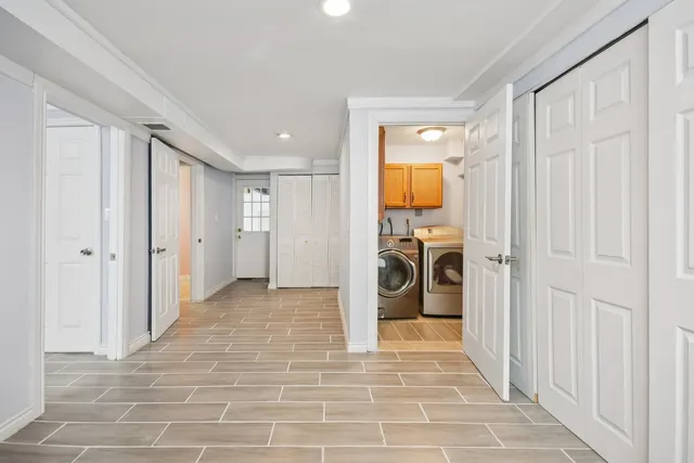 a view of a hallway with a livingroom and a fireplace