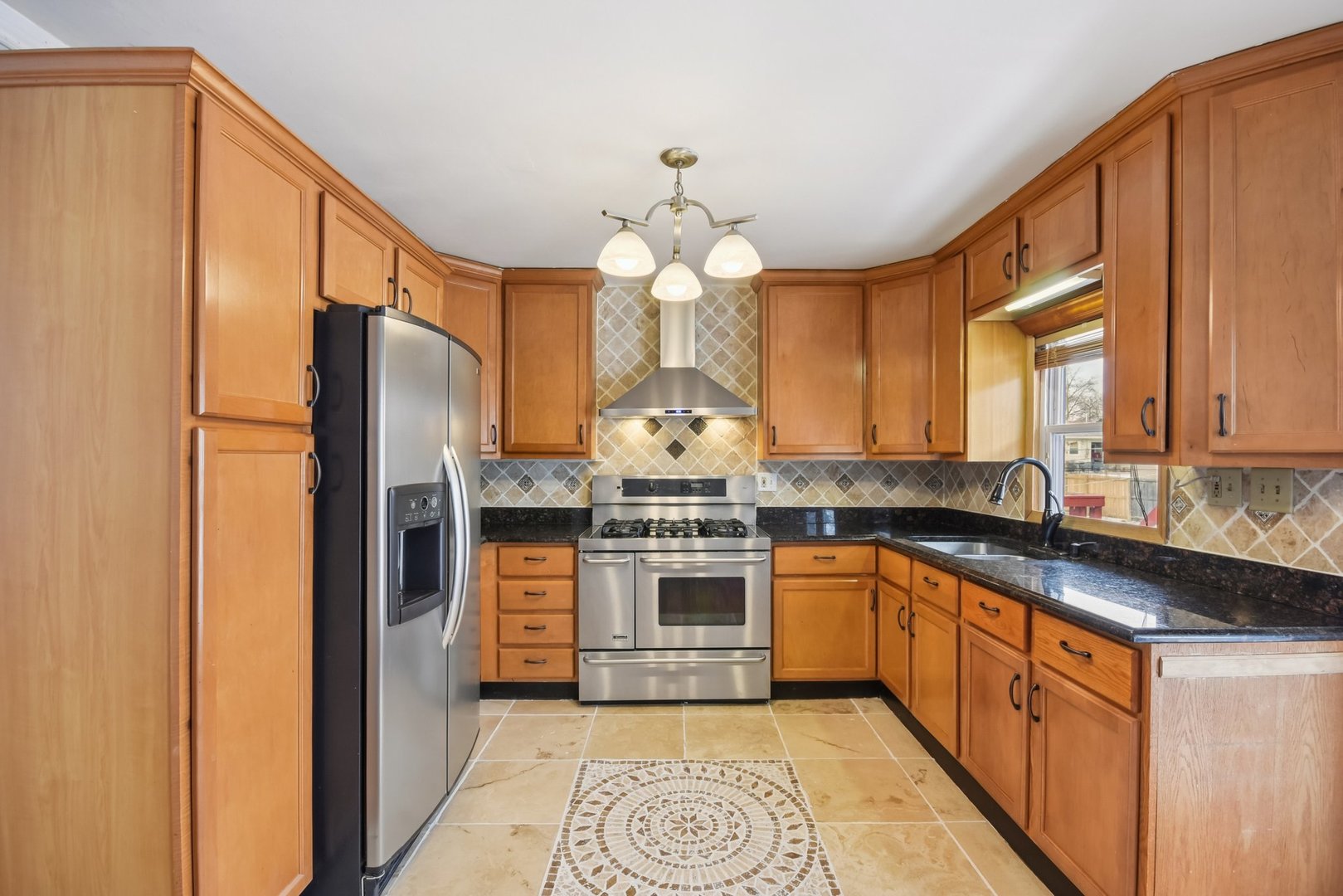 301 Villa Road Streamwood, IL 60107 - Photo 8 of 34 a kitchen with stainless steel appliances granite countertop a stove and a refrigerator