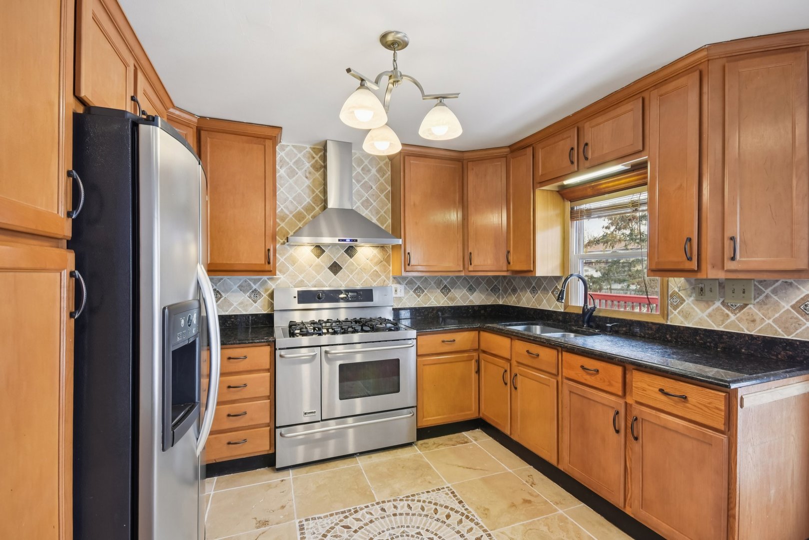 301 Villa Road Streamwood, IL 60107 - Photo 9 of 34 a kitchen with stainless steel appliances granite countertop a stove a sink and a refrigerator