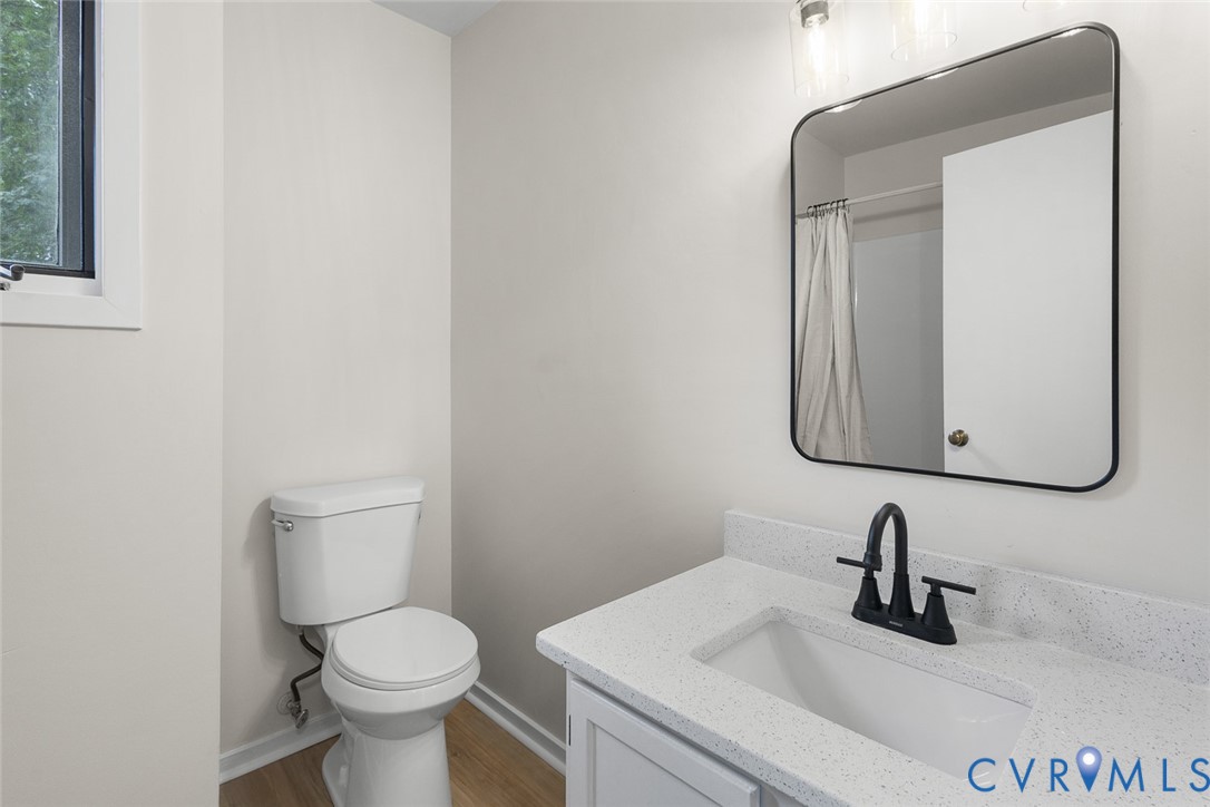 12916 Copperas Lane Henrico, VA 23233 - Photo 18 of 26 a bathroom with a toilet sink and mirror
