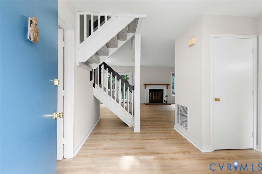 12916 Copperas Lane Henrico, VA 23233 - Photo 4 of 26 a view of staircase with lots of frames on wall and wooden floor