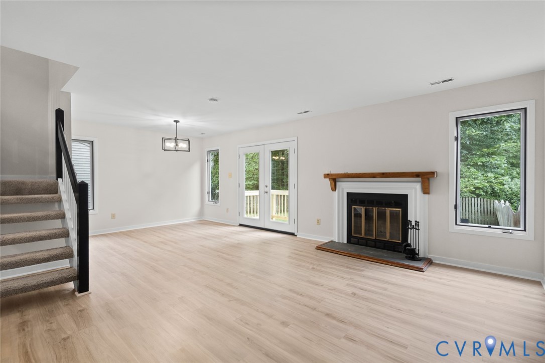 12916 Copperas Lane Henrico, VA 23233 - Photo 5 of 26 wooden floor fireplace and windows in an empty room