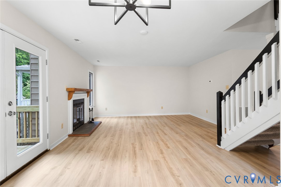 12916 Copperas Lane Henrico, VA 23233 - Photo 6 of 26 a view of empty room with wooden floor and fan