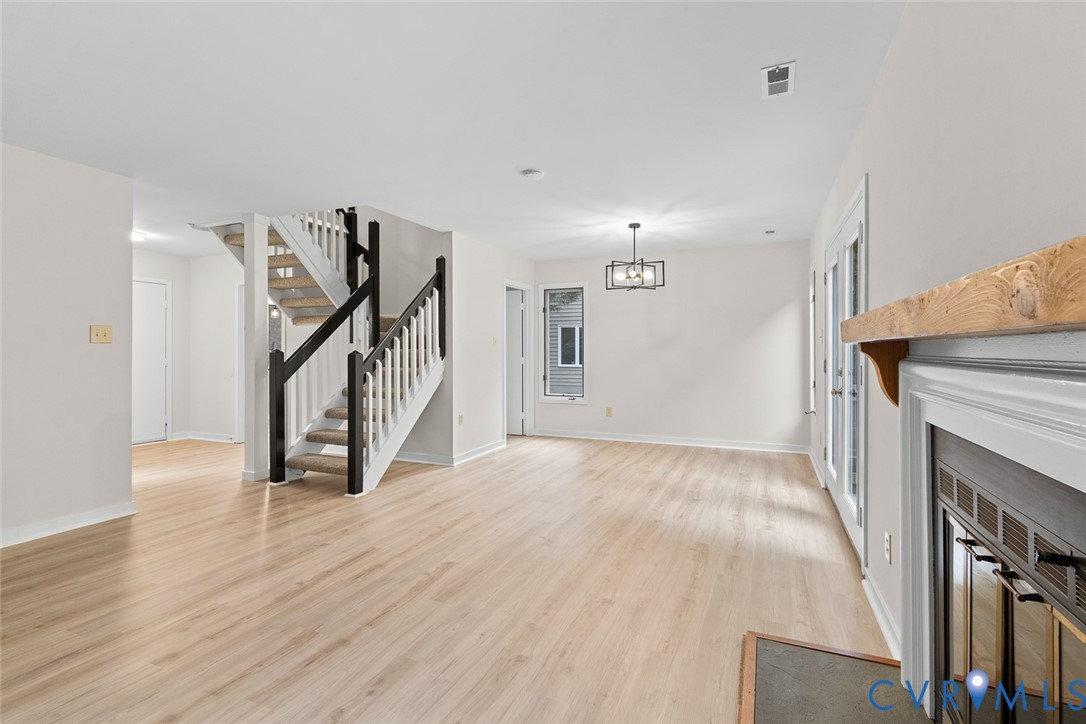 12916 Copperas Lane Henrico, VA 23233 - Photo 7 of 26 a view of empty room with wooden floor and fireplace