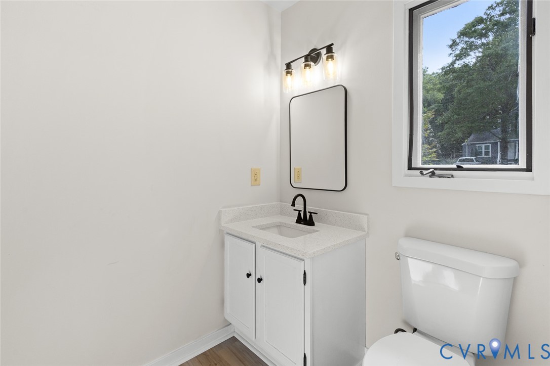 12916 Copperas Lane Henrico, VA 23233 - Photo 10 of 26 a bathroom with a toilet sink and mirror
