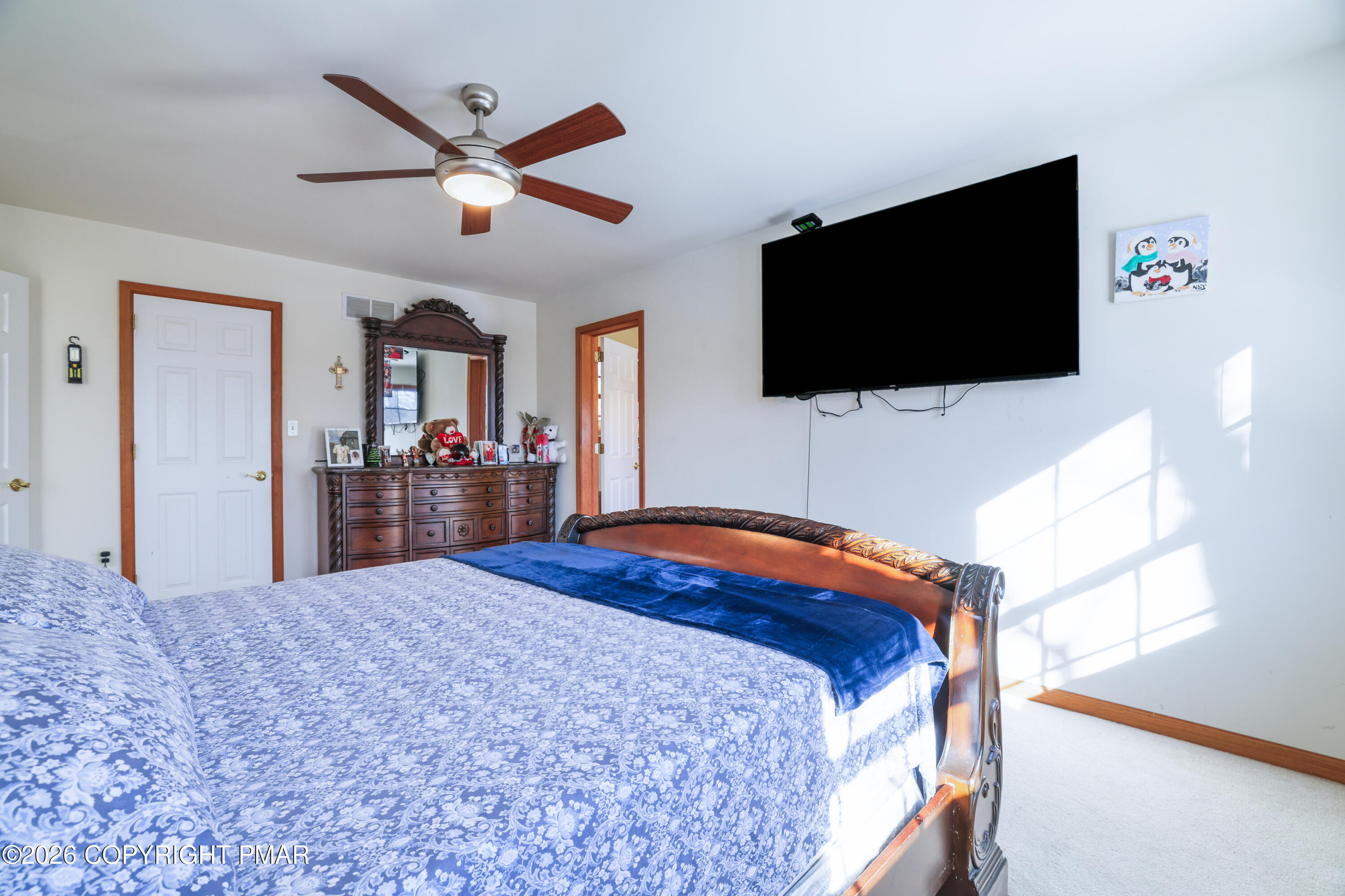 3220 Cherry Ridge Road Bushkill, PA 18324 - Photo 13 of 47 a bedroom with a large bed and a flat screen tv