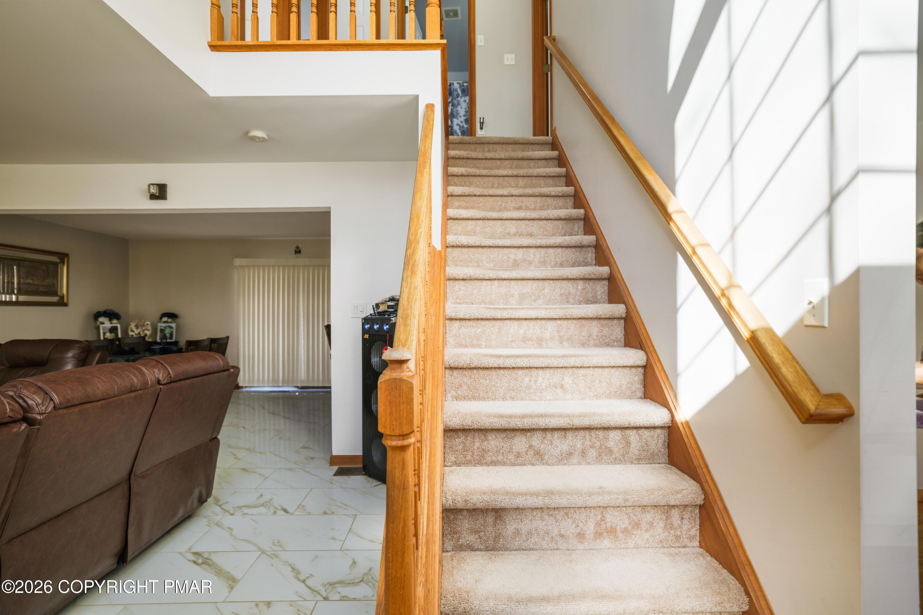 3220 Cherry Ridge Road Bushkill, PA 18324 - Photo 21 of 47 a view of staircase with lots of frames on wall and a large window