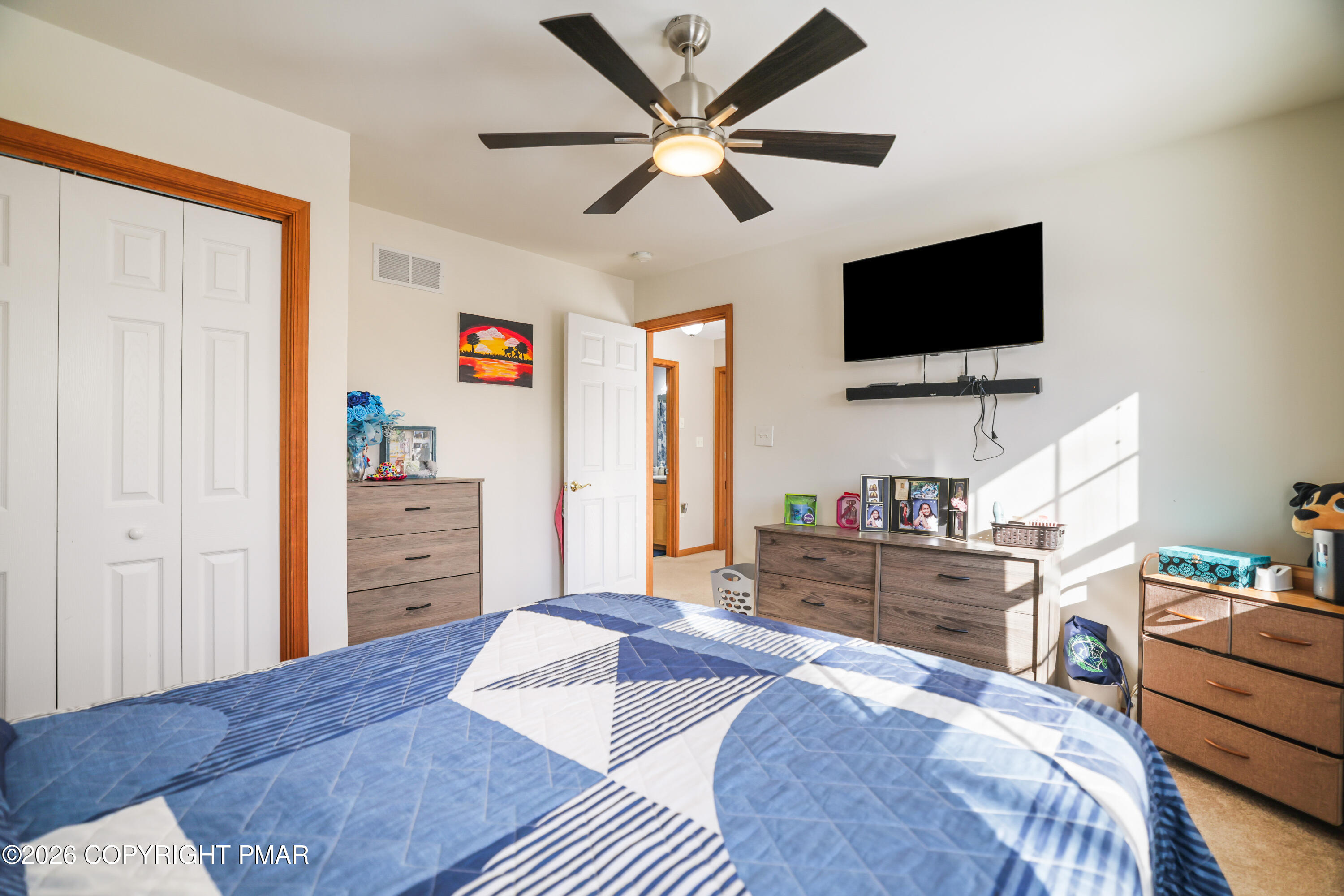 3220 Cherry Ridge Road Bushkill, PA 18324 - Photo 26 of 47 a bedroom with a bed window and a flat screen tv