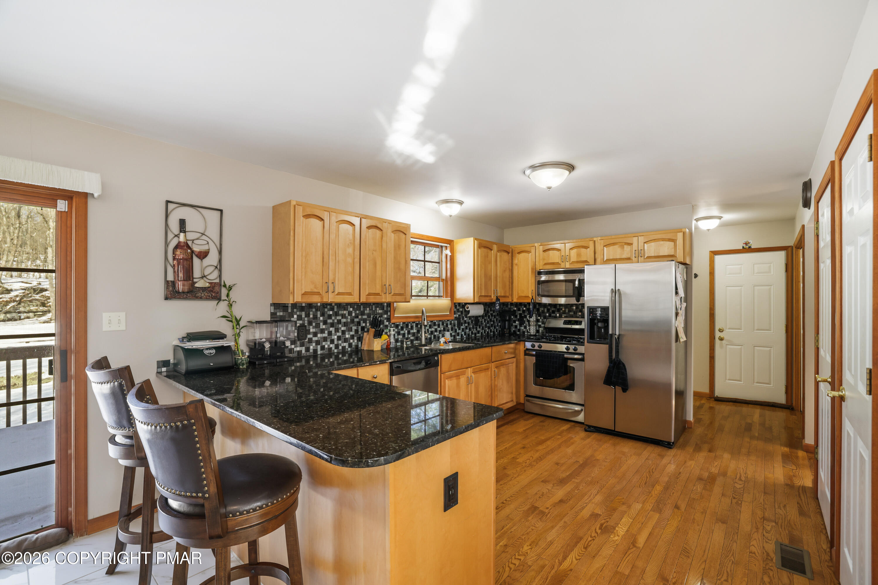 3220 Cherry Ridge Road Bushkill, PA 18324 - Photo 3 of 47 a kitchen with granite countertop a sink and refrigerator