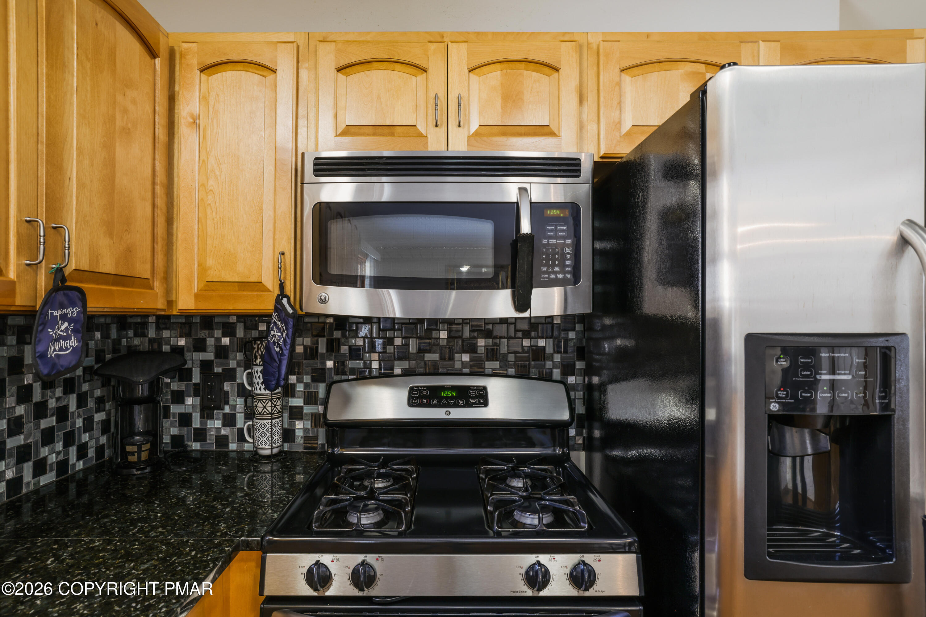 3220 Cherry Ridge Road Bushkill, PA 18324 - Photo 7 of 47 a kitchen with granite countertop a stove and a microwave