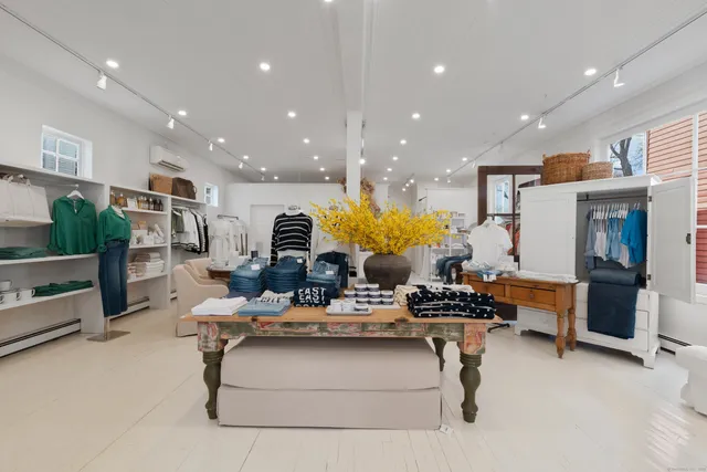 a large white kitchen with a large counter top appliances and cabinets