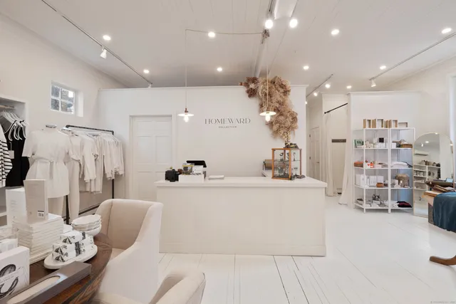 a living room with fireplace furniture and a view of kitchen