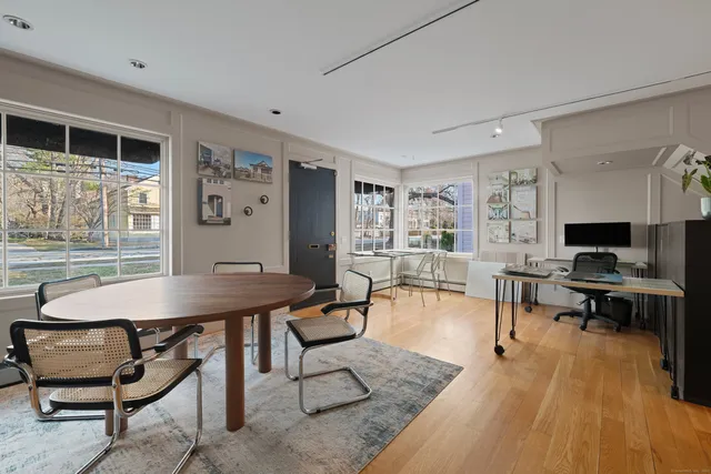 a view of a dining room with furniture window and wooden floor