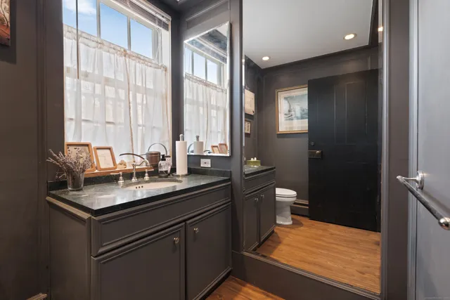 a view of a dining room with livingroom and wooden floor