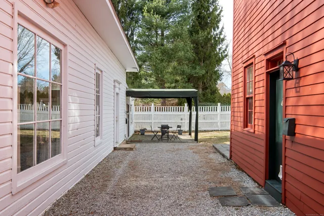 a view of a house with backyard and sitting area