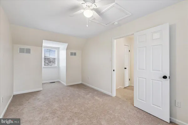 a view of an empty room with a ceiling fan
