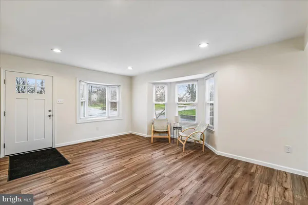 a view of a livingroom with wooden floor and a window