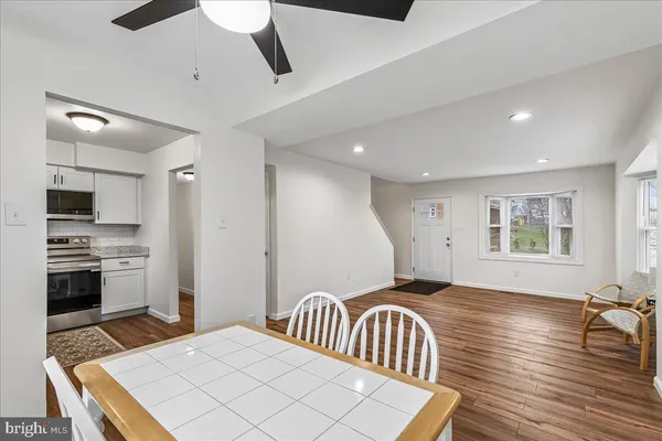 a spacious bedroom with a bed and a view of kitchen